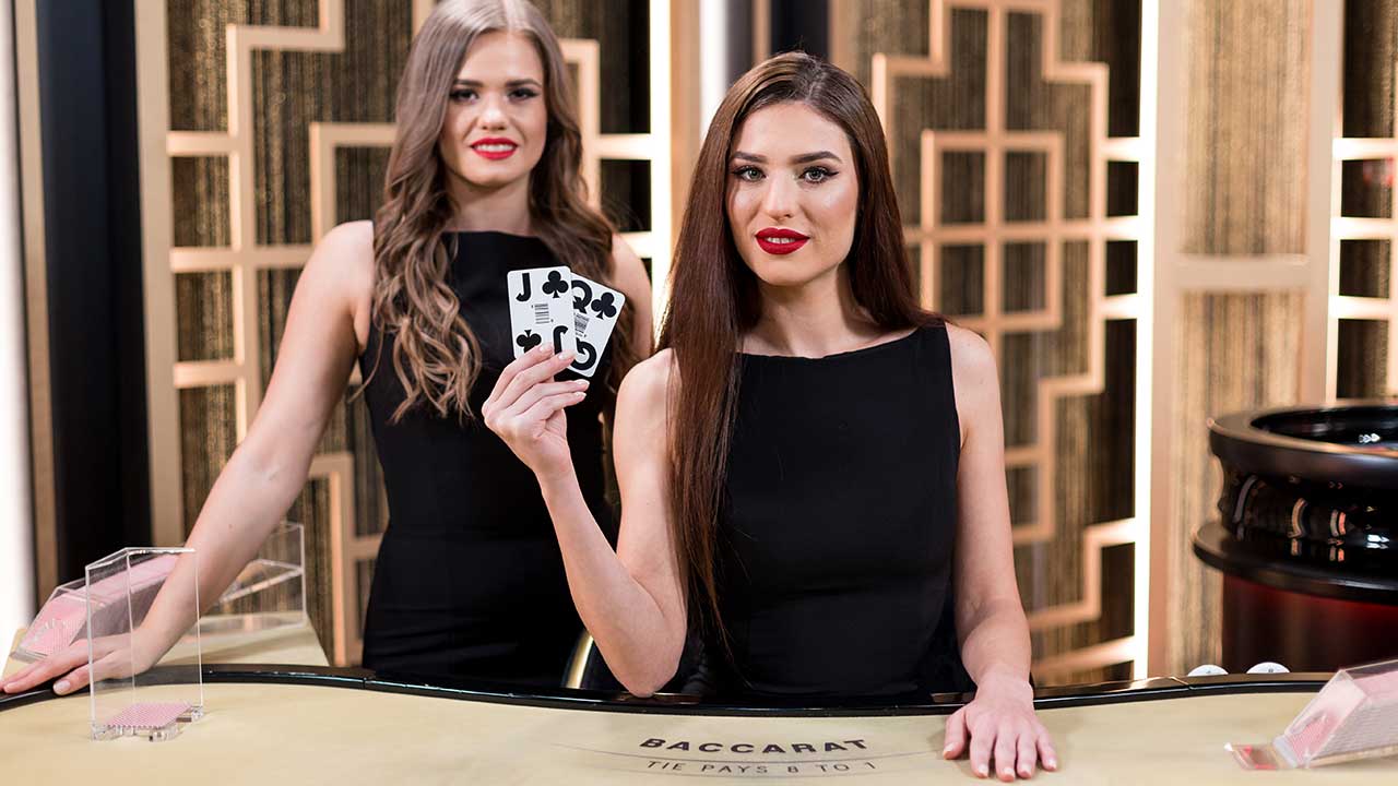 pretty female online baccarat dealers holding cards